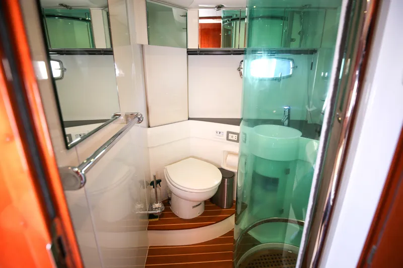  Yacht Photos Pics Luxurious bathroom in 2008 Fairline Targa 52 GT yacht with modern fixtures and wooden flooring.