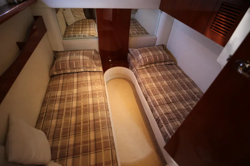  Yacht Photos Pics Interior cabin of 2008 Fairline Targa 52 GT with twin beds and plaid bedding.