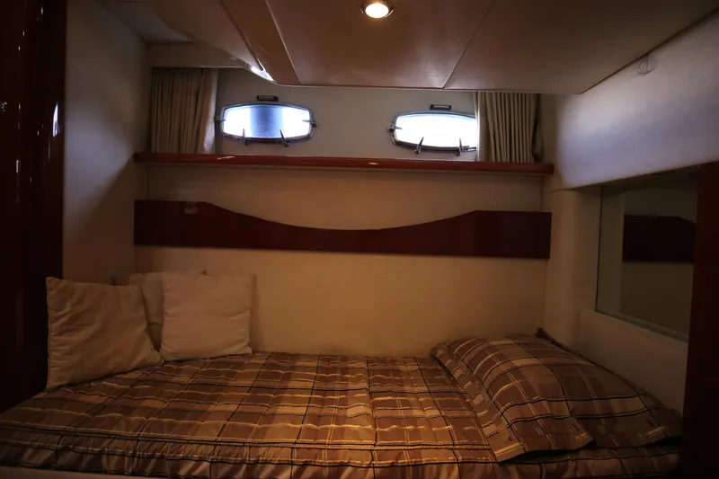  Yacht Photos Pics Interior cabin of 2008 Fairline Targa 52 GT yacht with cozy bed and porthole windows.