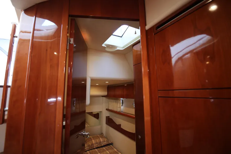  Yacht Photos Pics Interior of 2008 Fairline Targa 52 GT yacht with polished wood finish and cozy cabin.