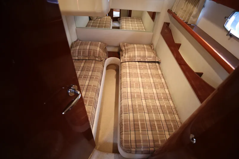  Yacht Photos Pics 2008 Fairline Targa 52 GT cabin with twin beds and plaid bedding.
