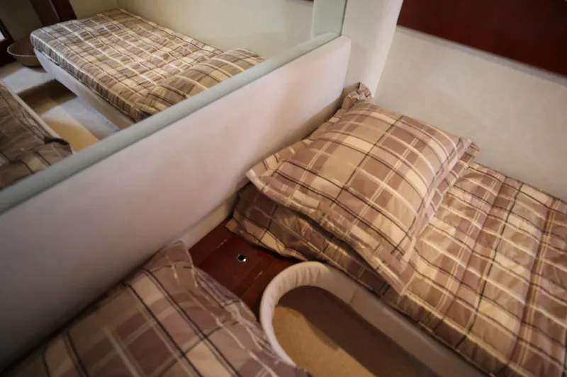  Yacht Photos Pics Interior cabin of 2008 Fairline Targa 52 GT with plaid bedding.