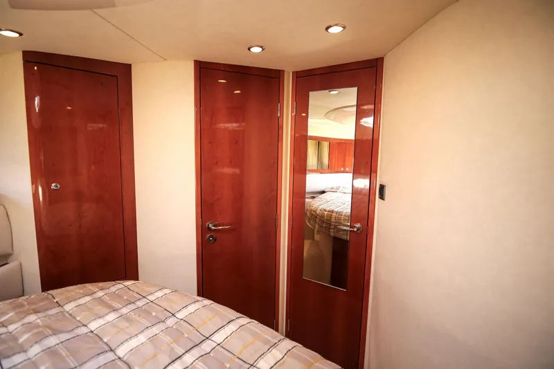  Yacht Photos Pics Luxurious interior of 2008 Fairline Targa 52 GT yacht with wooden doors and cozy bedding.