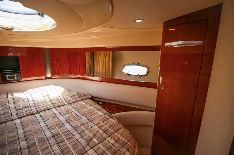  Yacht Photos Pics Luxurious 2008 Fairline Targa 52 GT yacht cabin with elegant wood finishes and cozy bedding.