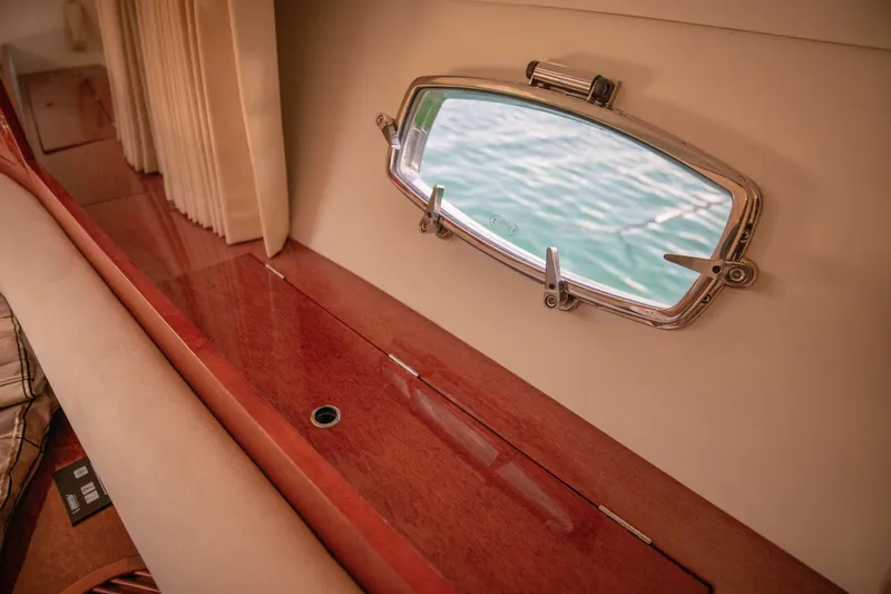  Yacht Photos Pics Interior of 2008 Fairline Targa 52 GT yacht with porthole and wooden finish.