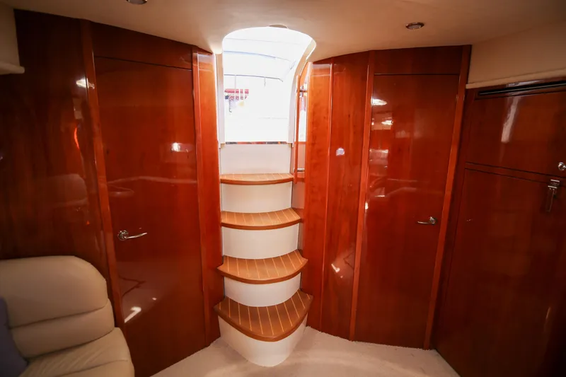  Yacht Photos Pics Luxurious interior of 2008 Fairline Targa 52 GT yacht with wooden cabinetry and staircase.