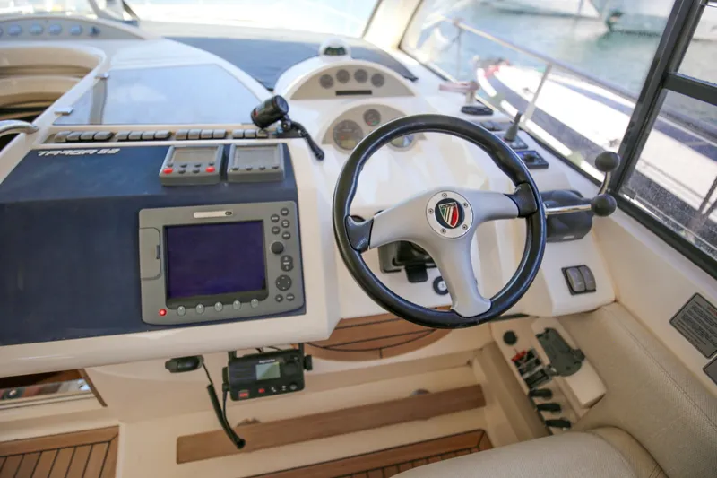  Yacht Photos Pics 2008 Fairline Targa 52 GT yacht helm with steering wheel and navigation controls.