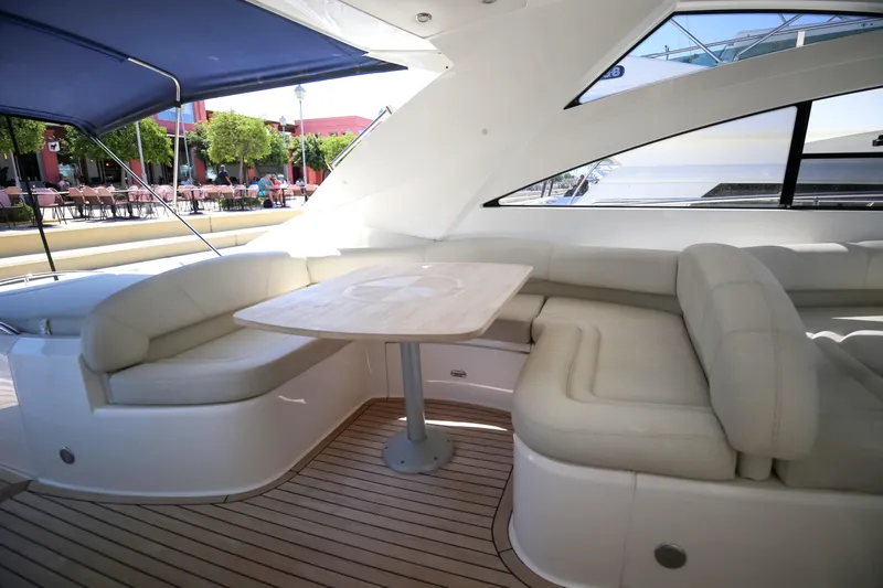  Yacht Photos Pics Luxurious seating area on 2008 Fairline Targa 52 GT yacht with elegant wooden table.