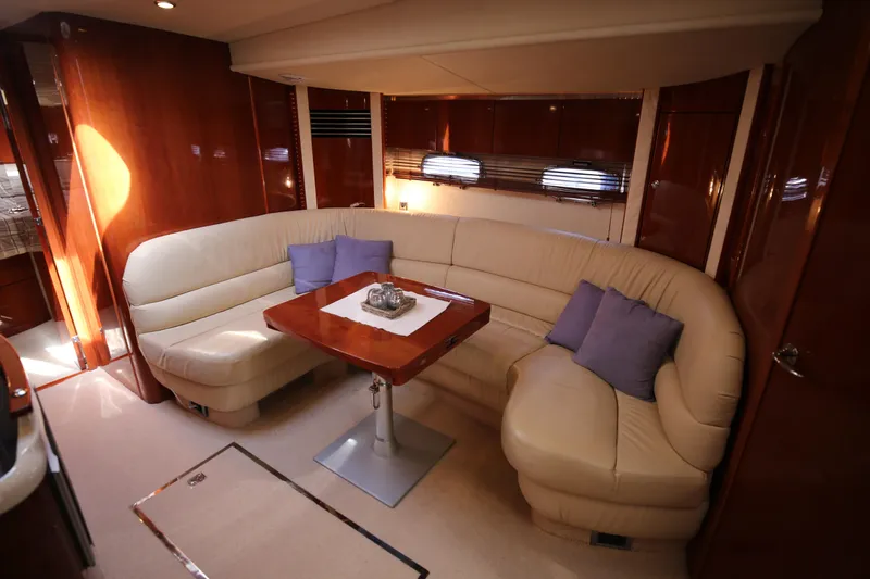  Yacht Photos Pics Luxurious interior of 2008 Fairline Targa 52 GT yacht with leather seating and wooden table.