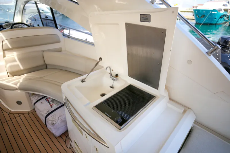  Yacht Photos Pics Interior of 2008 Fairline Targa 52 GT yacht with seating and kitchenette area.