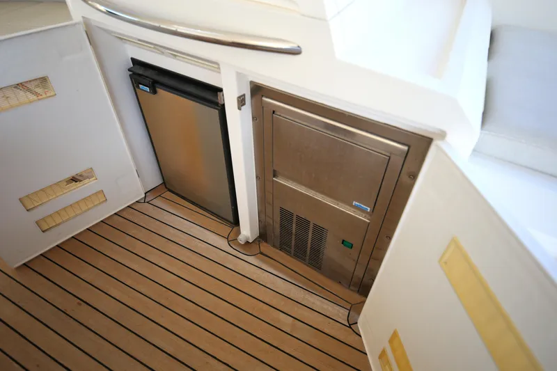  Yacht Photos Pics 2008 Fairline Targa 52 GT yacht interior with mini fridge and stainless steel appliance.