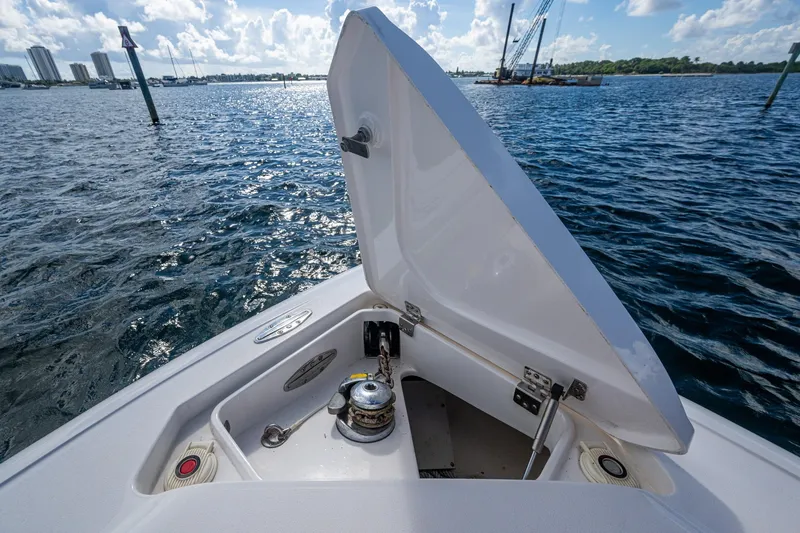 Match Point Yacht Photos Pics 2011 Intrepid 327 Center Console boat with open anchor locker on a sunny day.