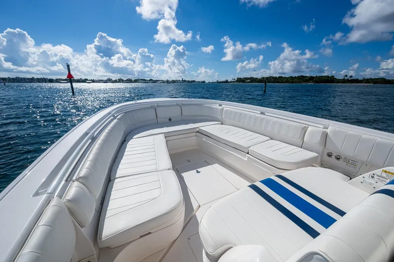 Match Point Yacht Photos Pics 2011 Intrepid 327 Center Console boat with white seating, on a sunny day at sea.