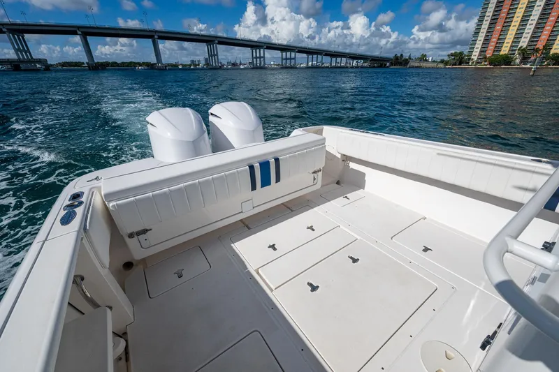Match Point Yacht Photos Pics 2011 Intrepid 327 Center Console boat on water near bridge and buildings.