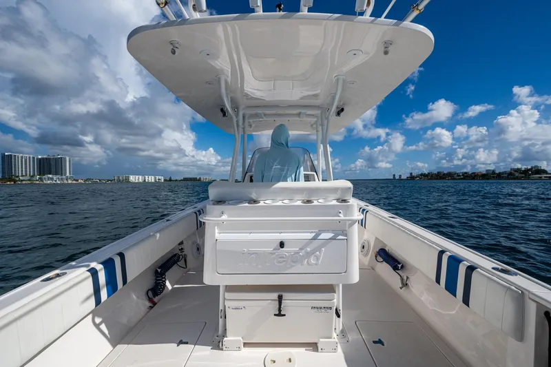 Match Point Yacht Photos Pics 2011 Intrepid 327 Center Console boat on open water under a partly cloudy sky.