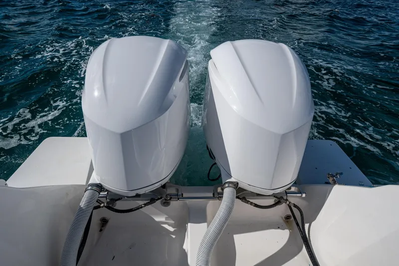 Match Point Yacht Photos Pics Twin outboard motors on a 2011 Intrepid 327 Center Console boat in open water.