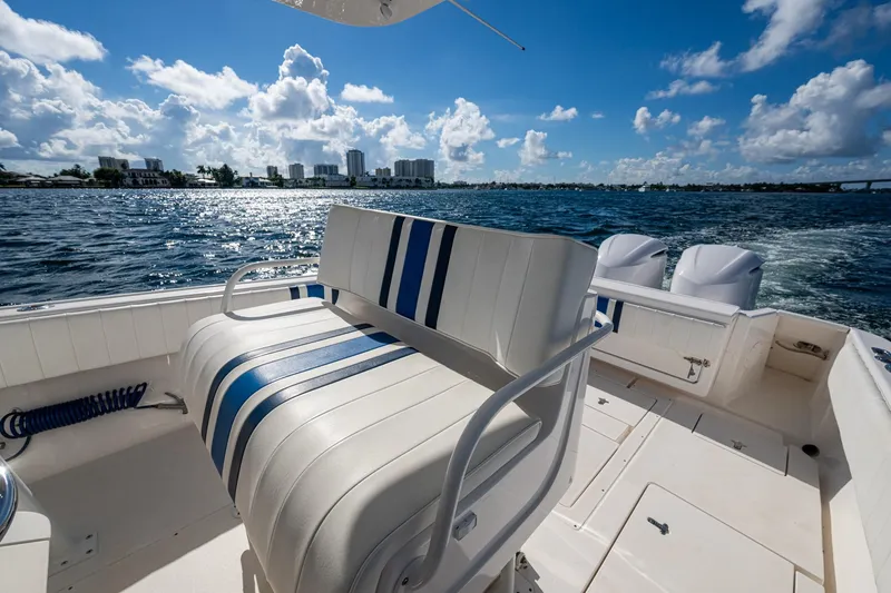 Match Point Yacht Photos Pics 2011 Intrepid 327 Center Console boat on water, sunny day, city skyline in background.