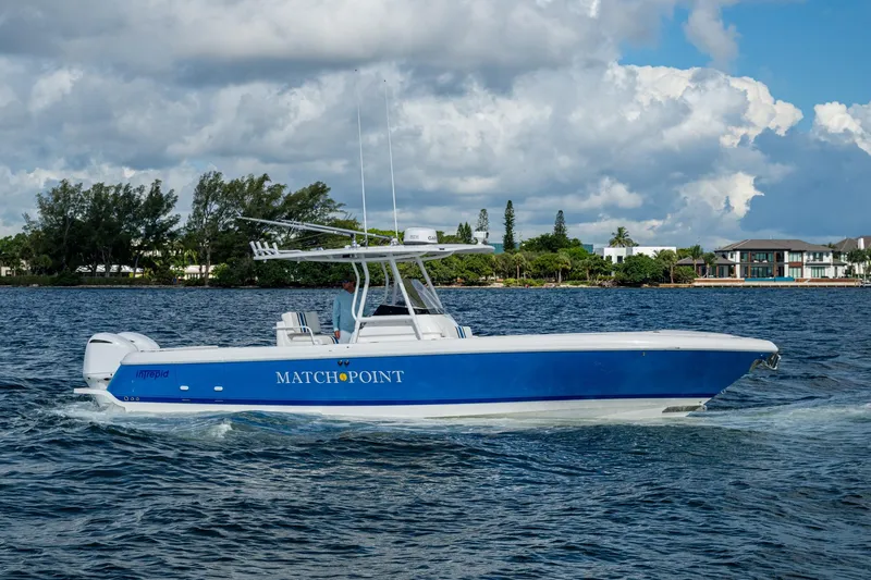 Match Point Yacht Photos Pics 2011 Intrepid 327 Center Console boat cruising on a scenic waterway.