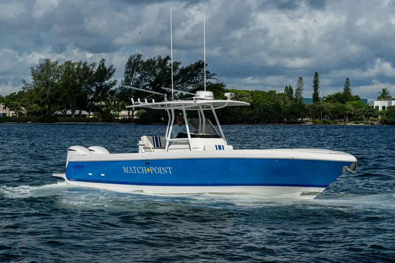 Match Point Yacht Photos Pics 2011 Intrepid 327 Center Console boat cruising on water under cloudy sky.