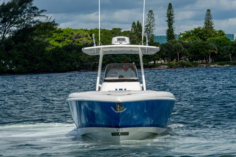Match Point Yacht Photos Pics 2011 Intrepid 327 Center Console boat cruising on a scenic waterway.