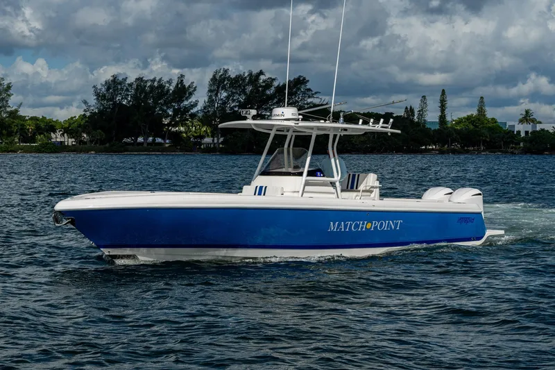 Match Point Yacht Photos Pics 2011 Intrepid 327 Center Console boat cruising on a scenic waterway.