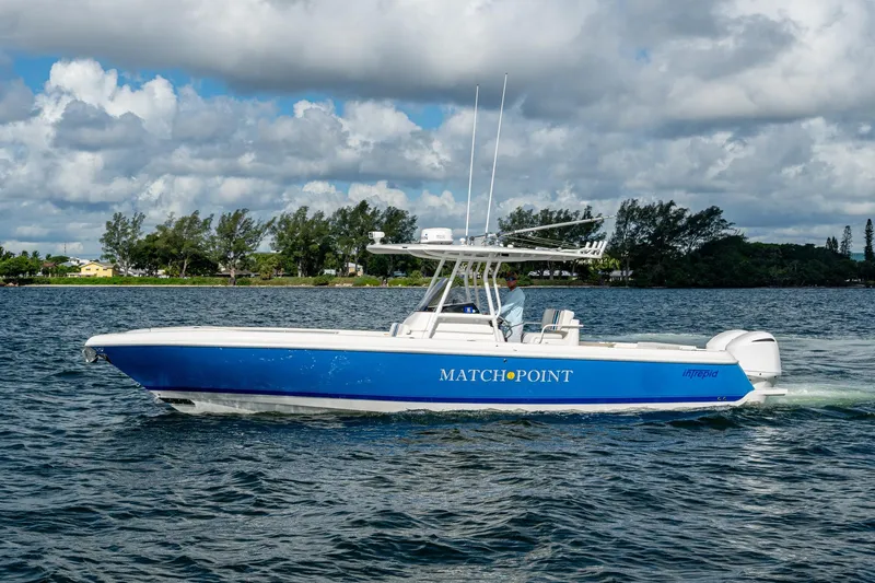 Match Point Yacht Photos Pics 2011 Intrepid 327 Center Console boat cruising on a scenic waterway.