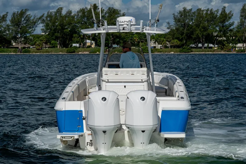 Match Point Yacht Photos Pics 2011 Intrepid 327 Center Console boat cruising on a scenic waterway.