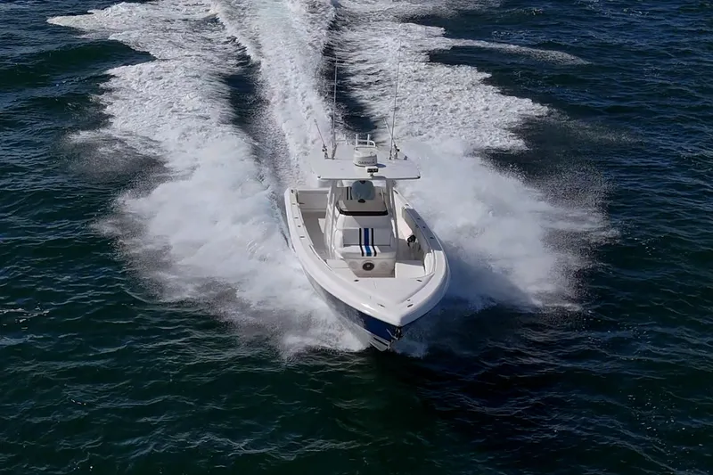 Match Point Yacht Photos Pics 2011 Intrepid 327 Center Console boat cruising on open water.