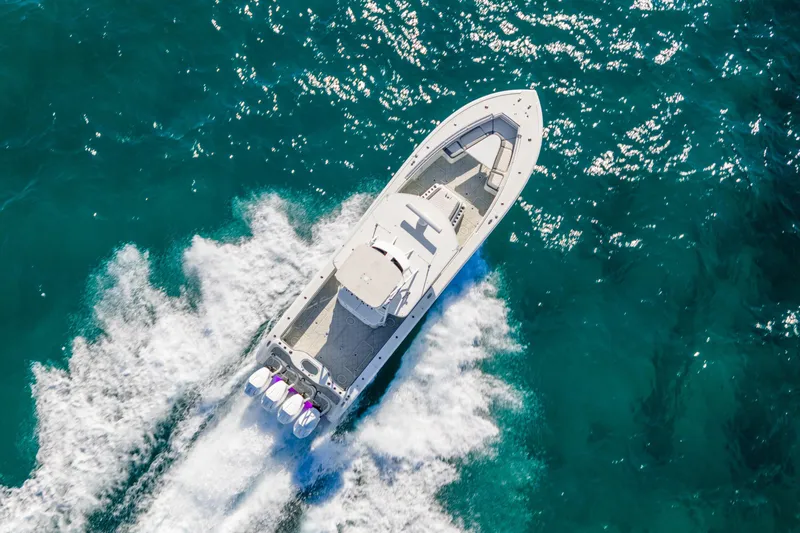 Yacht Photos Pics Aerial view of 2015 Yellowfin 42 Offshore boat cruising on clear blue ocean waters.