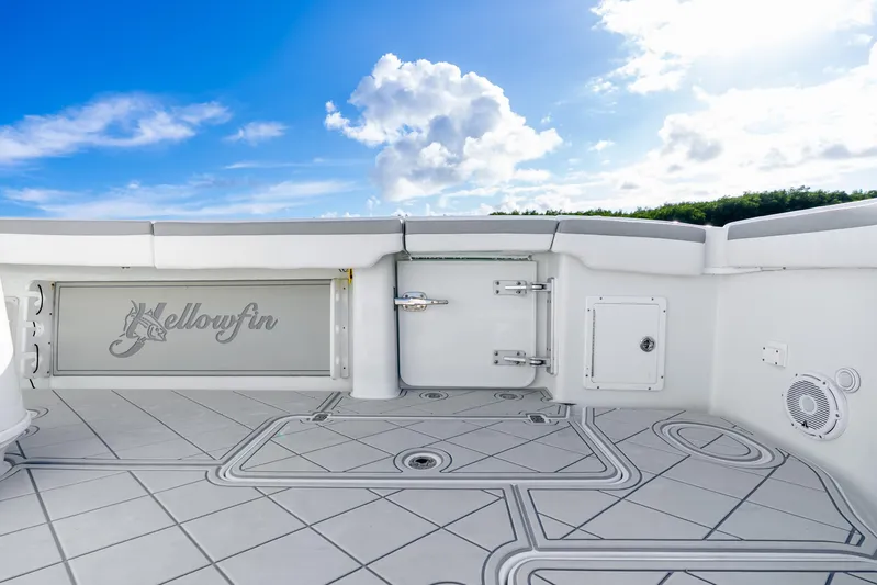  Yacht Photos Pics 2015 Yellowfin 42 Offshore boat deck with logo, under a bright blue sky.