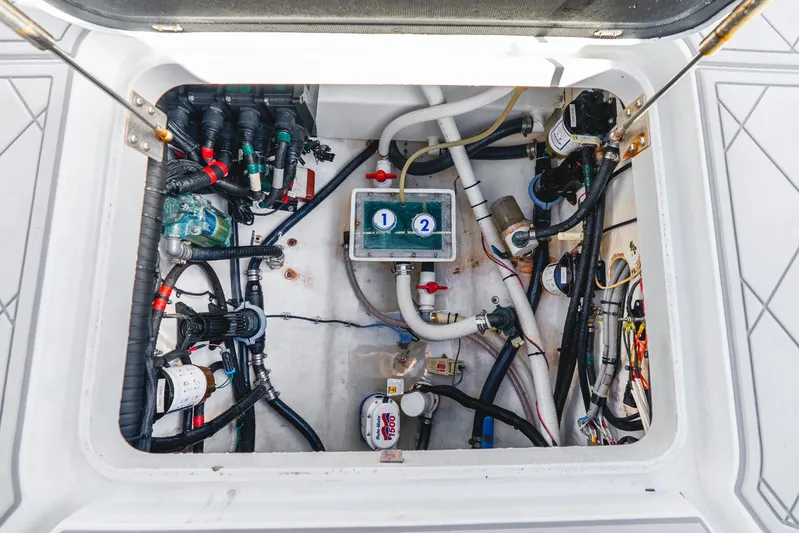  Yacht Photos Pics 2015 Yellowfin 42 Offshore boat engine compartment with various hoses and components.