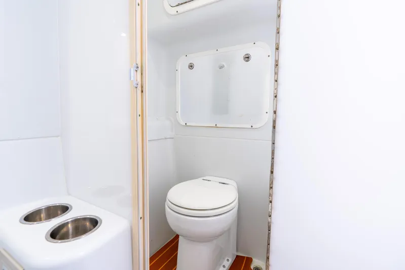  Yacht Photos Pics 2015 Yellowfin 42 Offshore boat bathroom with toilet and storage.