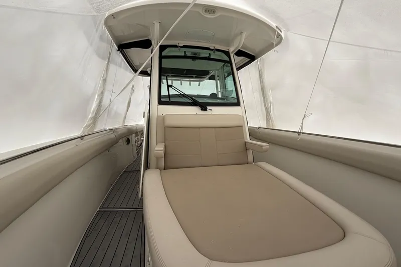 Yacht Photos Pics 2018 Boston Whaler 330 Outrage interior with cushioned seating and sleek design.