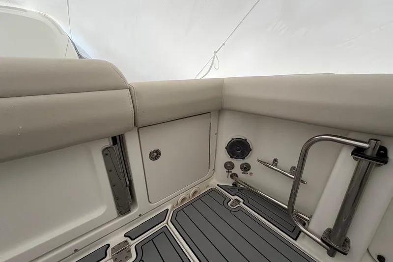  Yacht Photos Pics Interior view of a 2018 Boston Whaler 330 Outrage boat, featuring cushioned seating and stainless steel fixtures.