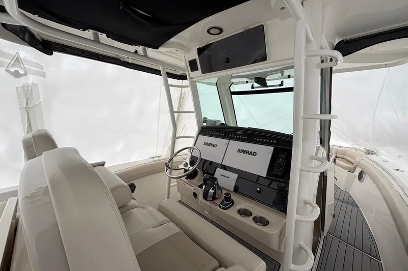  Yacht Photos Pics 2018 Boston Whaler 330 Outrage helm with Simrad electronics and luxurious seating.