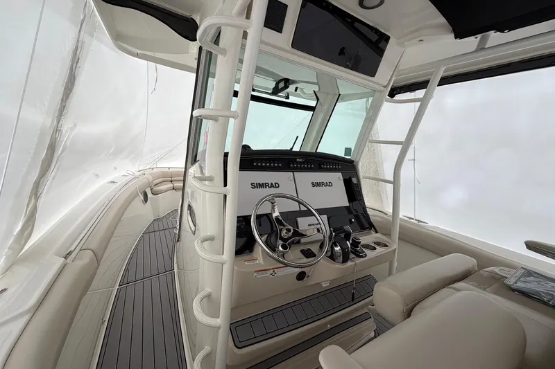 Yacht Photos Pics 2018 Boston Whaler 330 Outrage helm with Simrad electronics and luxurious seating.