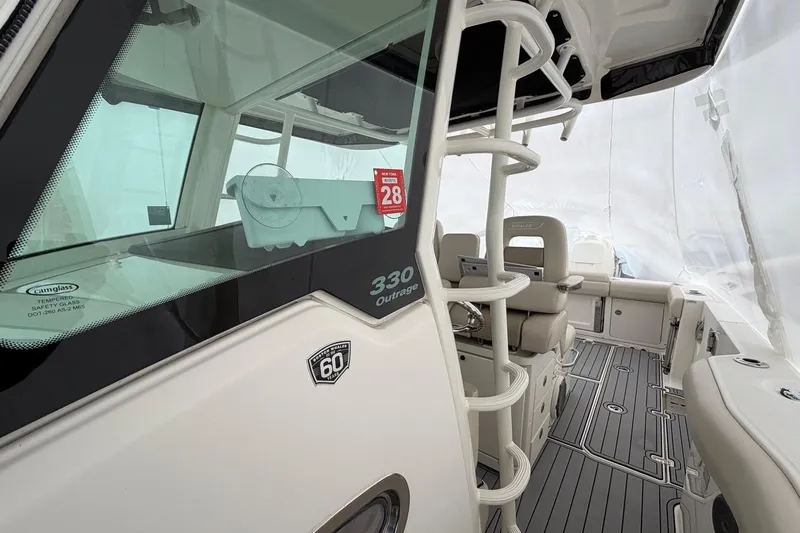  Yacht Photos Pics 2018 Boston Whaler 330 Outrage boat interior with seating and helm station.