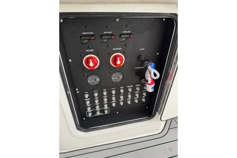  Yacht Photos Pics Control panel of a 2018 Boston Whaler 330 Outrage boat, featuring switches and dials.