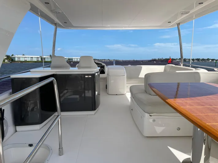  Yacht Photos Pics Luxurious 2015 Princess F56 yacht interior with seating and table, overlooking serene waters.