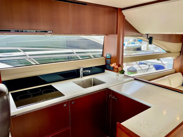  Yacht Photos Pics Luxurious yacht kitchen interior with modern appliances, sleek countertops, and large windows. Princess f56, 2015.