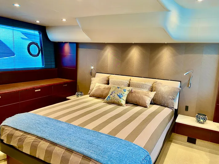  Yacht Photos Pics Luxurious bedroom interior of 2015 Princess f56 yacht with striped bedding and modern lighting.