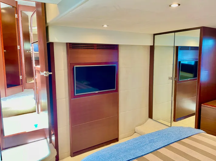  Yacht Photos Pics Luxurious interior of 2015 Princess f56 yacht with TV and mirrored closet.