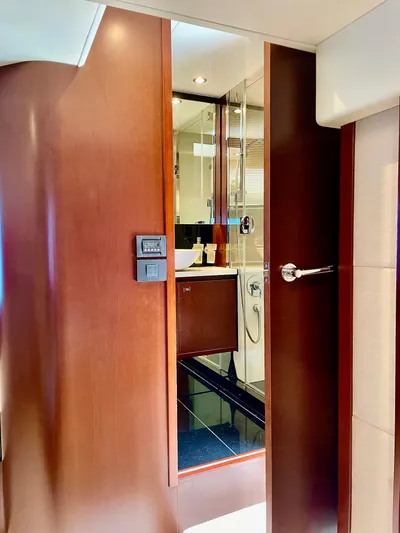  Yacht Photos Pics Luxurious yacht bathroom with wooden door, modern fixtures, and elegant design, Princess f56, 2015 model.