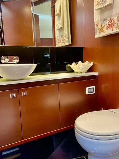  Yacht Photos Pics Luxurious yacht bathroom with modern sink, wooden cabinetry, and elegant decor. Princess f56, 2015 model.