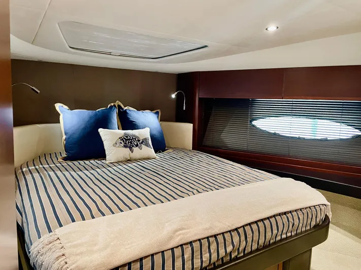  Yacht Photos Pics Luxurious cabin interior of 2015 Princess f56 yacht with cozy bed and elegant decor.