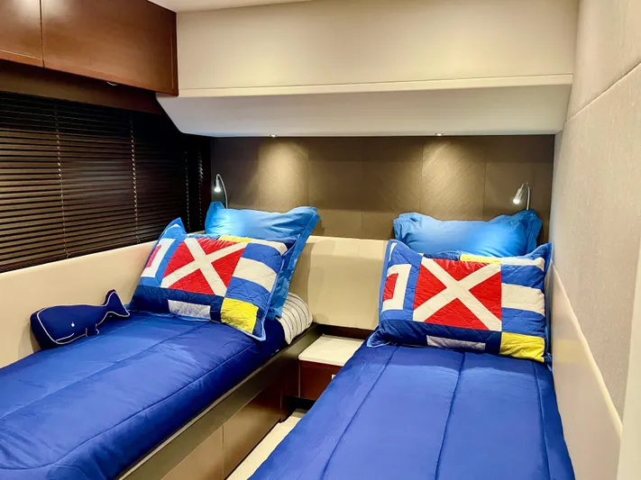 Yacht Photos Pics Twin beds with nautical-themed pillows in a 2015 Princess f56 yacht cabin.