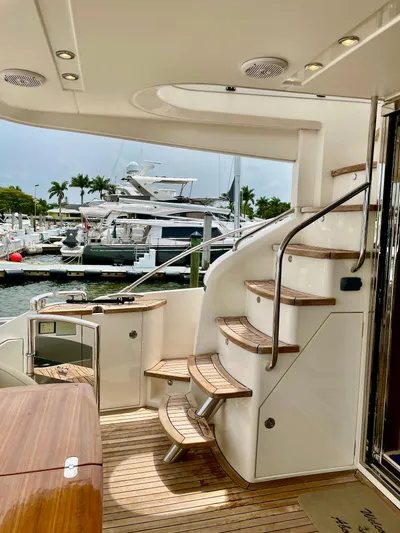  Yacht Photos Pics Luxurious 2015 Princess F56 yacht with elegant wooden stairs and marina view.