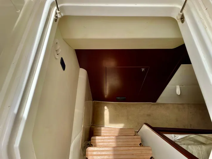  Yacht Photos Pics Staircase inside 2015 Princess f56 yacht, featuring wooden steps and modern interior design.