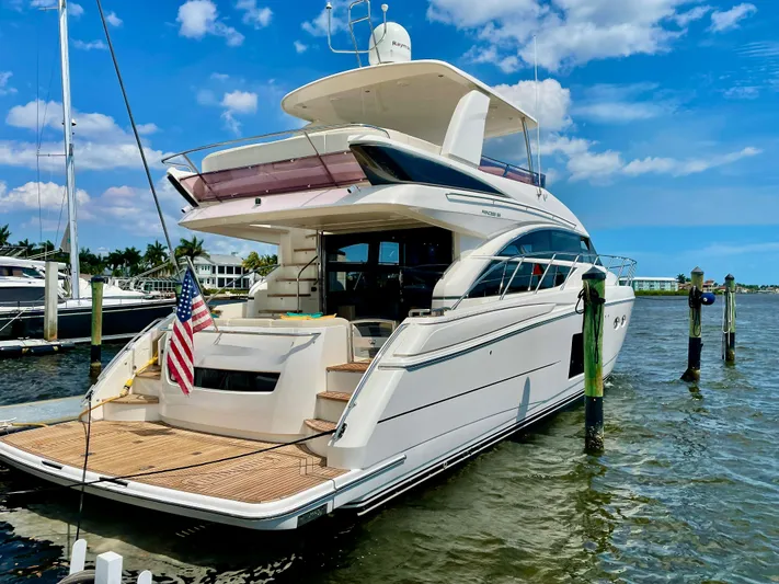  Yacht Photos Pics Luxury Princess f56 yacht docked, 2015 model, with American flag, under blue sky.