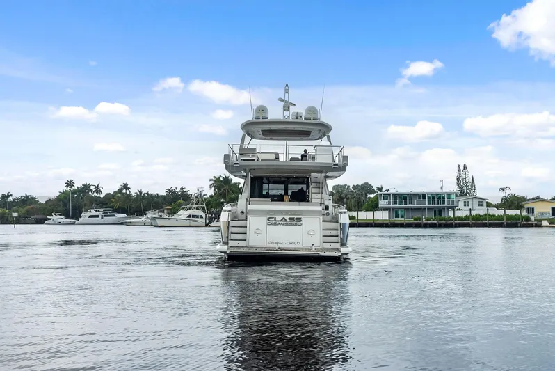 Class Dismissed Yacht Photos Pics Azimut 72 Flybridge 2017 yacht on calm water, with scenic background.